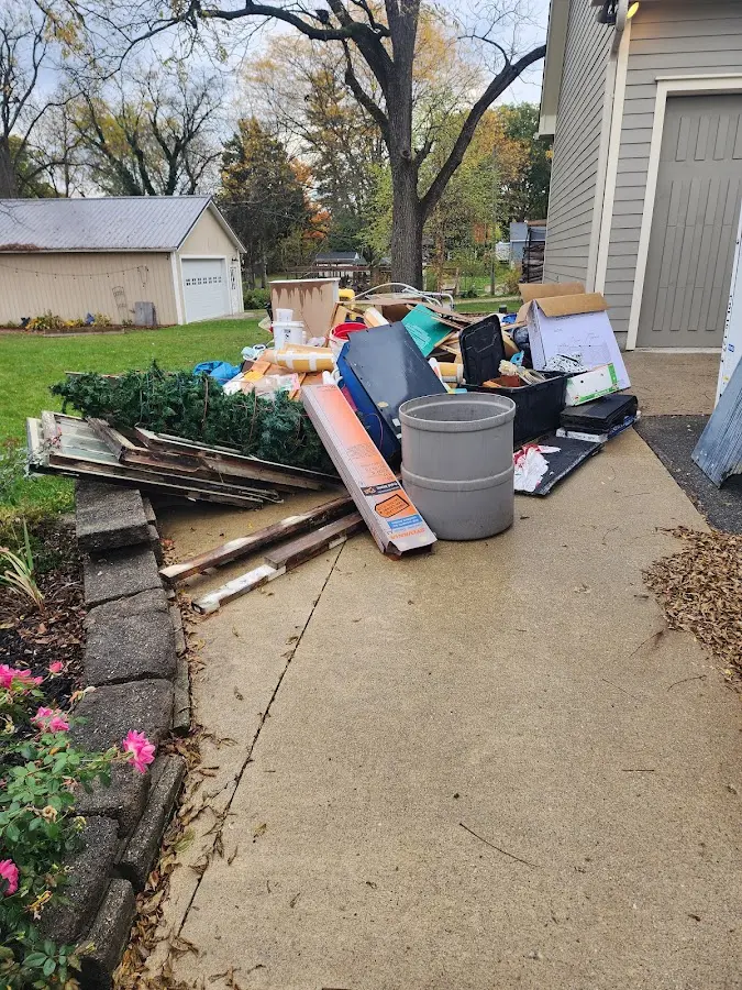 Dumpster being loaded with debris for 12 Yard Dumpster Rental in Loyola